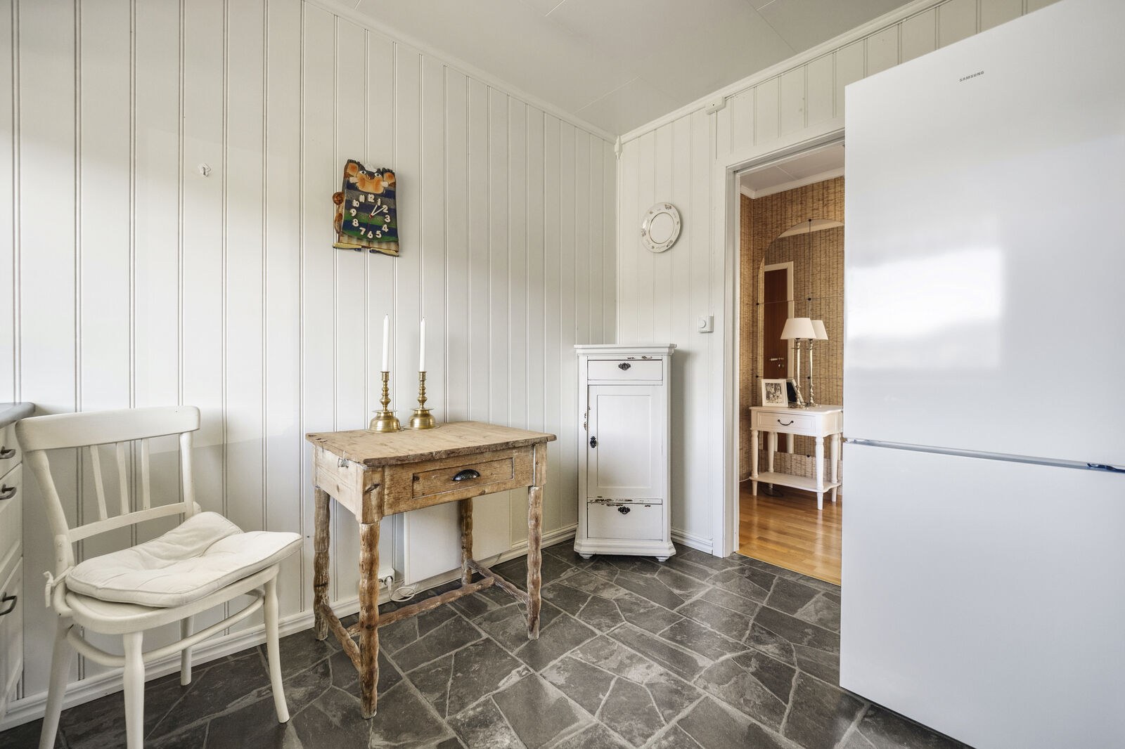 Det er komfyr og oppvaskmaskin i benk og plass til frittstaaende kjoeleskap samt et lite kjoekkenbord